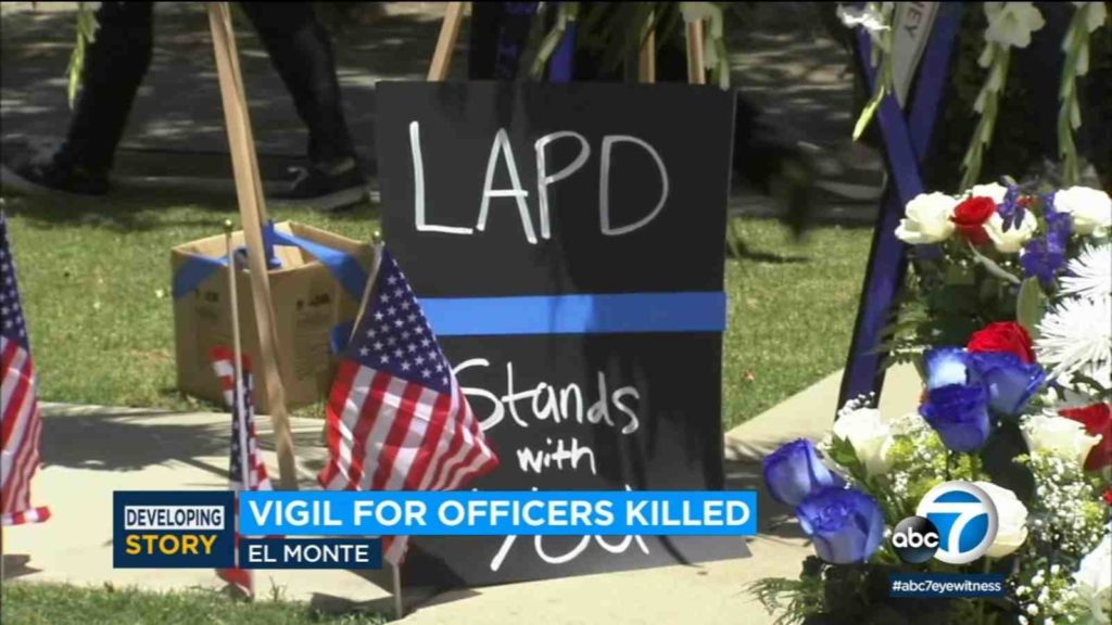 Hundreds of people gather for vigil to remember two California police officers shot dead